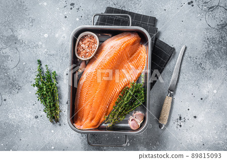 Ready for cooking raw salmon fish fillet with herbs in steel tray. Gray background. Top view 89815093