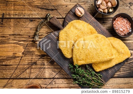 Cordon bleu meat cutlets with bread crumbs on a wooden board. wooden background. Top view. Copy space 89815279
