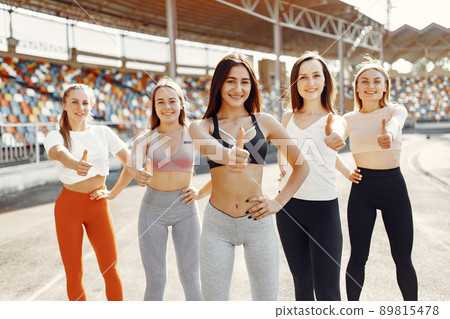 Beautiful girls at the stadium. Sports girls in a sportswear. Beautiful girls at the stadium. Sports girls in a sportswear. 89815478