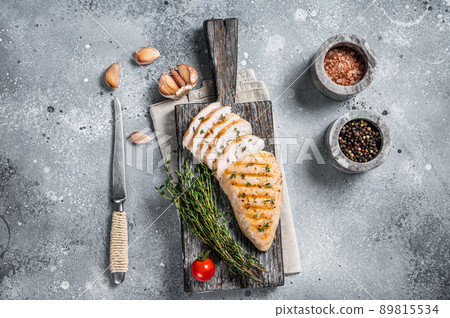 Sliced Turkey grilled breast fillet steak on a cutting board. Gray background. Top view Sliced Turkey grilled breast fillet steak on a cutting board. Gray background. Top view 89815534