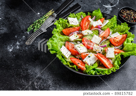 Bowl of ready-to-eat Greek salad. Black background. Top view. Copy space 89815782
