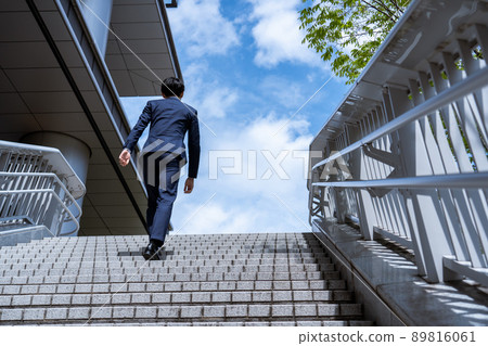 Businessman walking the stairs Businessman walking the stairs 89816061