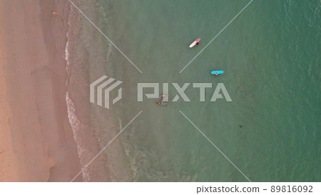 Top view of a group of surfers in the water. 89816092