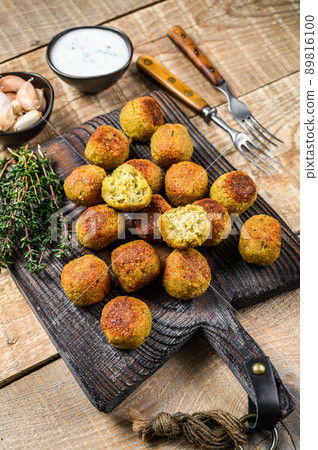 Chickpeas falafel with tzatziki sauce on a wooden board. wooden background. Top view 89816100