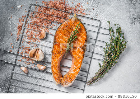 BBQ grilled Salmon Fish Steak on a grill with thyme and pink salt. White background. Top view 89816150