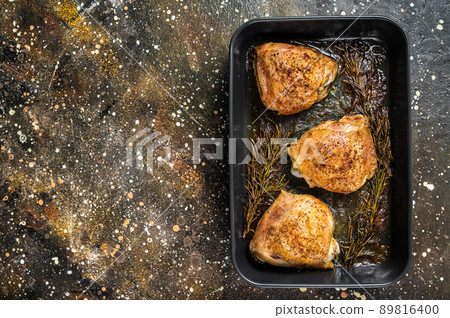 Oven Roasted chicken thighs with spices in baking dish. Brown background. Top View. Copy space Oven Roasted chicken thighs with spices in baking dish. Brown background. Top View. Copy space 89816400