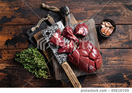Raw lamb kidney, fresh offal meat on butcher board with herbs. Wooden background. Top view Raw lamb kidney, fresh offal meat on butcher board with herbs. Wooden background. Top view 89816599