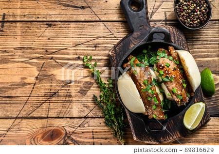 Bao bun, steamed sandwich with pork. Wooden background. Top view. Copy space 89816629