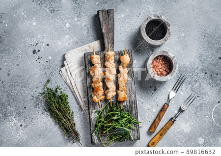 Grilled shish kebab with Chicken meat, poultry skewers with salad. Gray background. Top view 89816632