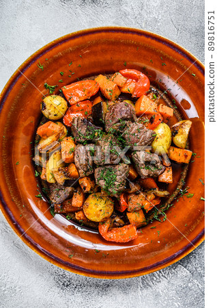 Meat stew, goulash on a plate. White background. Top view 89816751