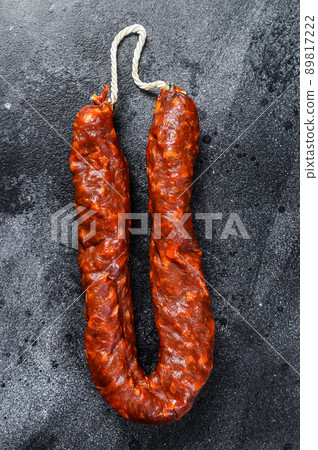 Spanish chorizo pork cured sausage. Black background. Top view Spanish chorizo pork cured sausage. Black background. Top view 89817222