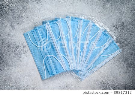 Blue ear loop surgical face masks. Disposable procedural face mask with malleable nose clip. White background. Top view 89817312