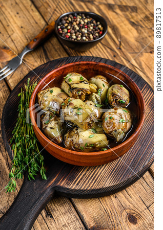Artichoke hearts pickled in olive oil. wooden background. Top view 89817513