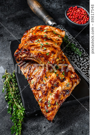 Barbecue pork rack spare ribs on a marble board. Black background. Top view Barbecue pork rack spare ribs on a marble board. Black background. Top view 89817548