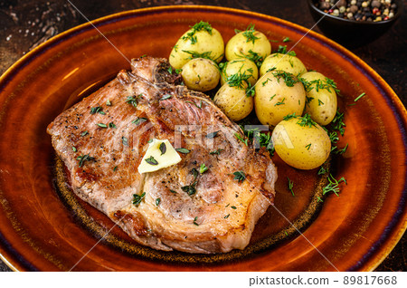 BBQ pork loin meat steak with potato. Dark background. Top view 89817668