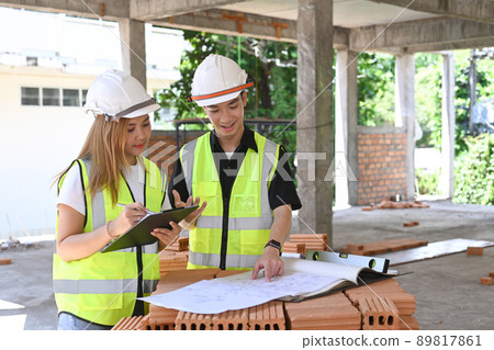 Two inspectors or engineer working and discussing about construction project together 89817861