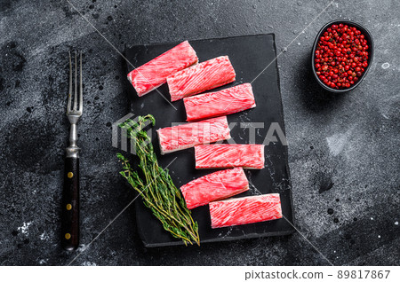 Crab surimi sticks on marble board. Black background. Top view Crab surimi sticks on marble board. Black background. Top view 89817867