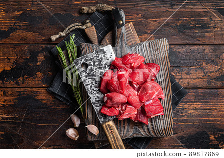 Raw Chopped beef veal meat on butcher board. Wooden background. Top view Raw Chopped beef veal meat on butcher board. Wooden background. Top view 89817869