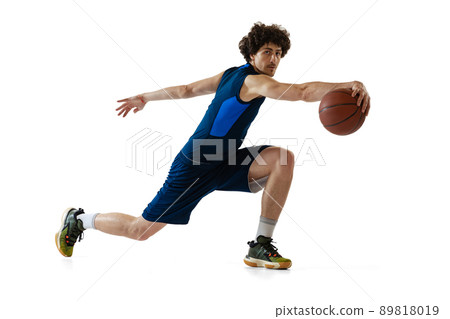 Young muscular basketball player in action, motion isolated on white background. Concept of sport, movement, energy and dynamic, healthy lifestyle. 89818019
