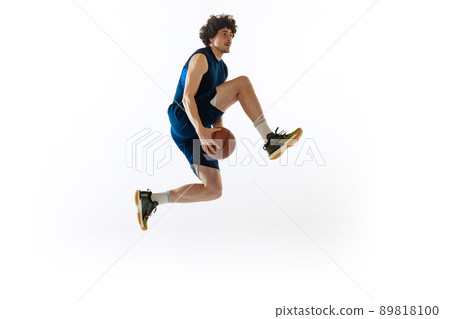 Dynamic portrait of young man, basketball player playing basketball isolated on white background. Concept of sport, movement, energy and action Dynamic portrait of young man, basketball player playing basketball isolated on white background. Concept of sport, movement, energy and action 89818100