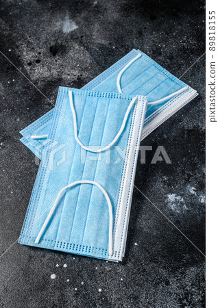 Doctor mask and corona virus protection. Disposable procedural face mask with malleable nose clip. Black background. Top view 89818155
