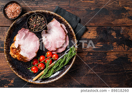 Smoked pork meat - gammon with herbs on rustic plate. Wooden background. Top view. Copy space 89818260