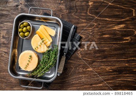 Fresh Halloumi sliced cheese in kitchen tray with thyme. Wooden background. Top view. Copy space 89818465