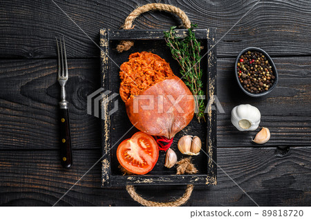 Mallorcan Sobrassada cured pork meat sausage in a wooden tray. Black wooden background. Top view Mallorcan Sobrassada cured pork meat sausage in a wooden tray. Black wooden background. Top view 89818720