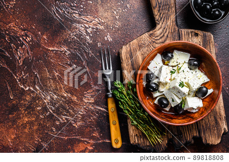 Salad with fresh feta cheese, thyme and olives. Dark background. Top view. Copy space Salad with fresh feta cheese, thyme and olives. Dark background. Top view. Copy space 89818808