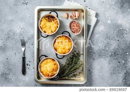 Irish Shepherd's pie with mince meat, mashed potato and cheddar cheese crust. Gray background. Top view Irish Shepherd's pie with mince meat, mashed potato and cheddar cheese crust. Gray background. Top view 89819087
