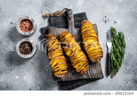 Crispy Tornado or twist potatoes chips on wooden board. Gray background. Top view Crispy Tornado or twist potatoes chips on wooden board. Gray background. Top view 89819164