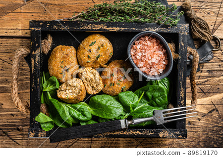 Seafood Fish balls or Fish cake with spinach and herbs in a tray. Wooden background. Top view Seafood Fish balls or Fish cake with spinach and herbs in a tray. Wooden background. Top view 89819170