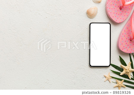 Flat lay composition with Phone and beach accessories on colored background. Smartphone with blank screen mock up with copy space Flat lay composition with Phone and beach accessories on colored background. Smartphone with blank screen mock up with copy space 89819326