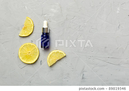 Bottles with lemon fruit essential oil on wooden background. alternative medicine top view with copy space 89819346