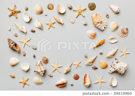 Summer time concept Flat lay composition with beautiful starfish and sea shells on colored table, top view with copy space for text 89819960