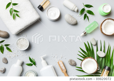Coconut with jars of coconut oil and cosmetic cream on colored background. Top view. Free space for your text. Natural spa coconut cosmetics and organic treatment concept Coconut Spa composition Coconut with jars of coconut oil and cosmetic cream on colored background. Top view. Free space for your text. Natural spa coconut cosmetics and organic treatment concept Coconut Spa composition 89820072
