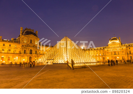 Louvre Museum illuminated at night in Paris, France 89820324