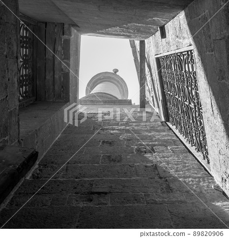 From below rectangular old narrow skylight with decorated windows overlooking old minaret 89820906