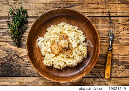 Italian Risotto with Scallops in a pan. wooden background. Top view 89821249