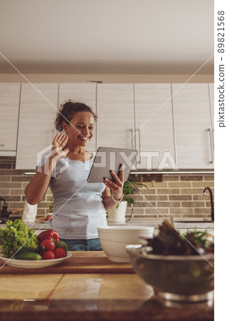 A woman blogs about cooking and is going to cook a salad A woman blogs about cooking and is going to cook a salad 89821568