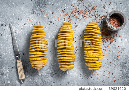 Cooking Tornado or Twist potato fries. Gray background. Top view. Copy space. Cooking Tornado or Twist potato fries. Gray background. Top view. Copy space. 89821620