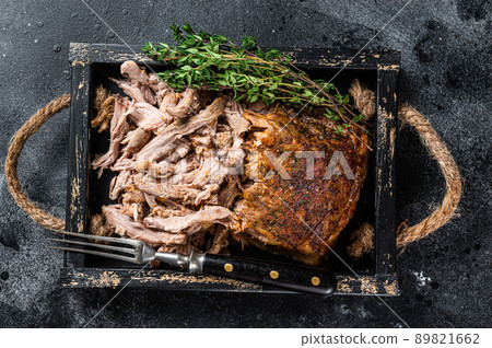 Bbq slow roast puilled pork meat in a wooden tray. Black background. Top view Bbq slow roast puilled pork meat in a wooden tray. Black background. Top view 89821662