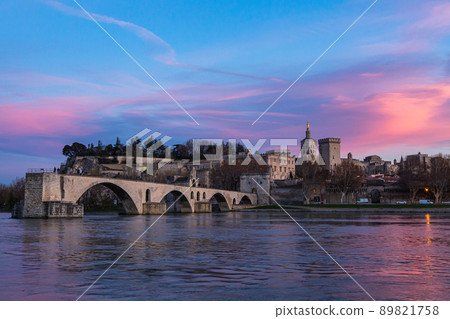 Pont d'Avignon in Avignon and Notre Dame de Don Cathedral under the sunset-dyed sky in France 89821758