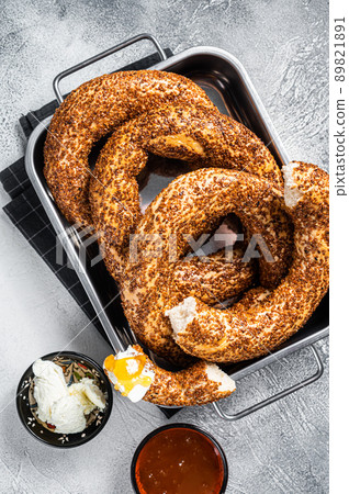 Homemade baked Turkish simit or Gevrek bagel with kaymak and honey. Gray background. Top view 89821891