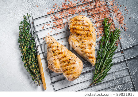 Grilled chicken breasts steaks cooked on a summer BBQ. Gray background. Top view Grilled chicken breasts steaks cooked on a summer BBQ. Gray background. Top view 89821933