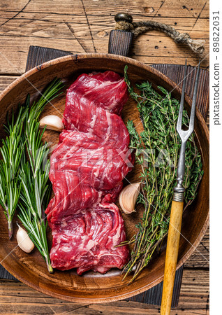Prime Raw machete skirt beef steak in woode plate with herbs. wooden background. Top view Prime Raw machete skirt beef steak in woode plate with herbs. wooden background. Top view 89822031