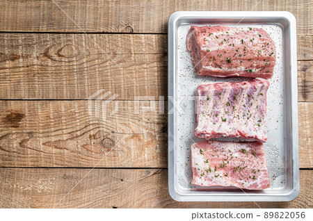 Set of Raw pork cuts, loin meat, spare ribs and brisket. Wooden background. Top view. Copy space Set of Raw pork cuts, loin meat, spare ribs and brisket. Wooden background. Top view. Copy space 89822056