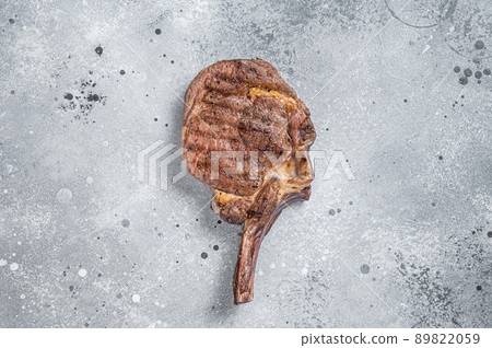 Grilled Beef Steak Tomahawk, Rib eye. Gray background. Top view Grilled Beef Steak Tomahawk, Rib eye. Gray background. Top view 89822059
