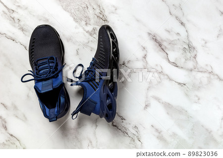 Laced up grooved men shoes on a marble floor. 89823036