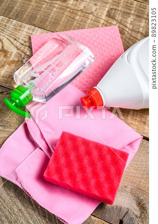Pink domestic supplies for spring cleaning service. wooden background. Top view 89823105